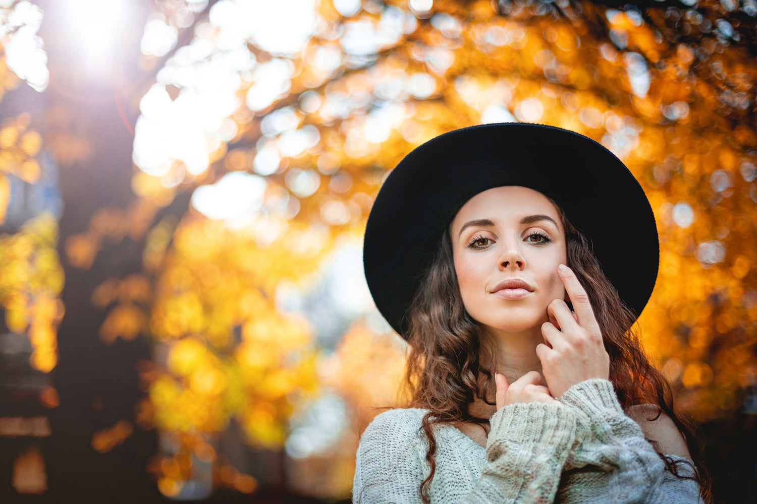 Moisturizer and skincare products with autumn leaves and cozy textures, perfect for fall and winter routines at Natural Beauty Spa.